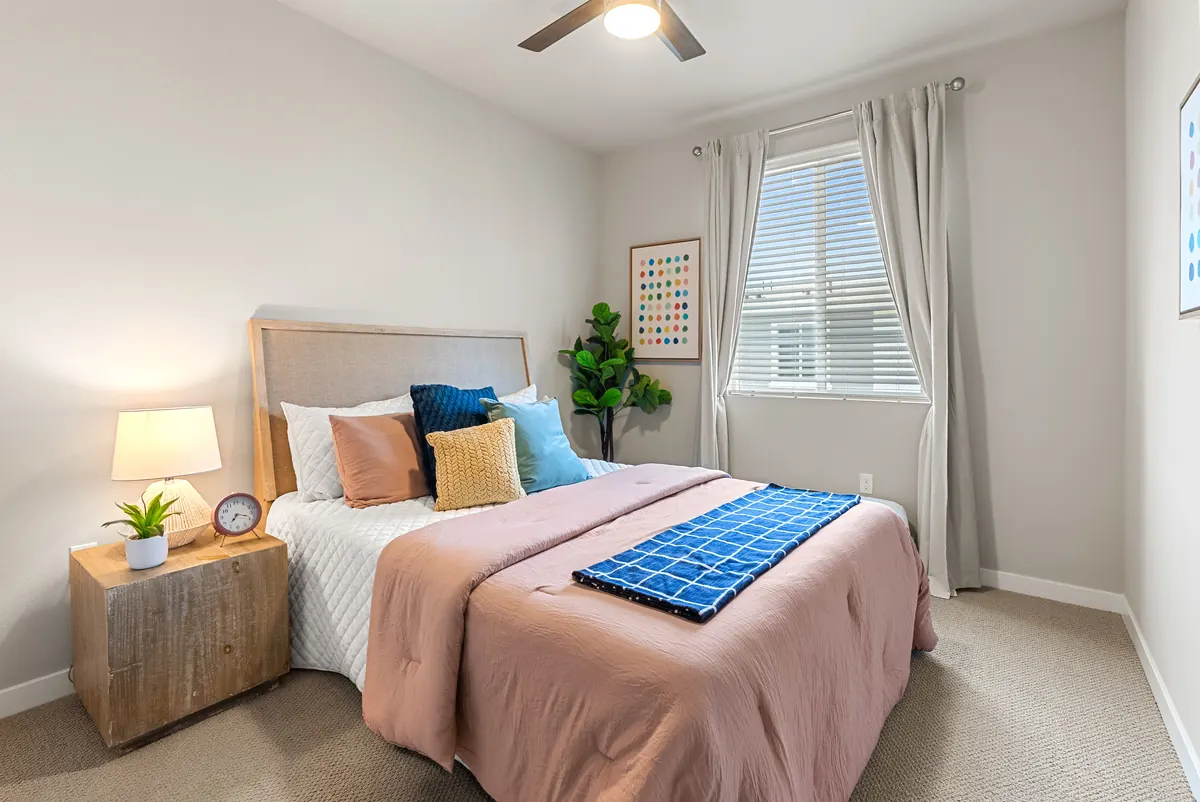 Staged bedroom with upholstered bed in a Cabrilla II home at Ponte Vista