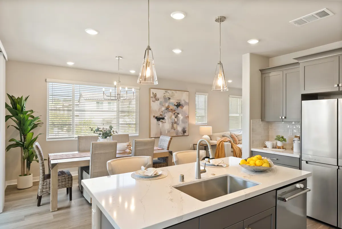 Open kitchen, dining, and living area in a staged Cabrilla II home at Ponte Vista