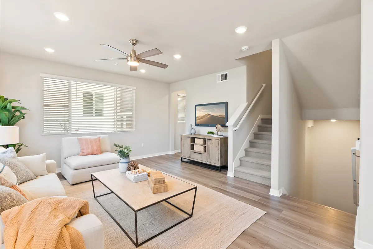 Staged living room with neutral furnishings in a Cabrilla II home at Ponte Vista