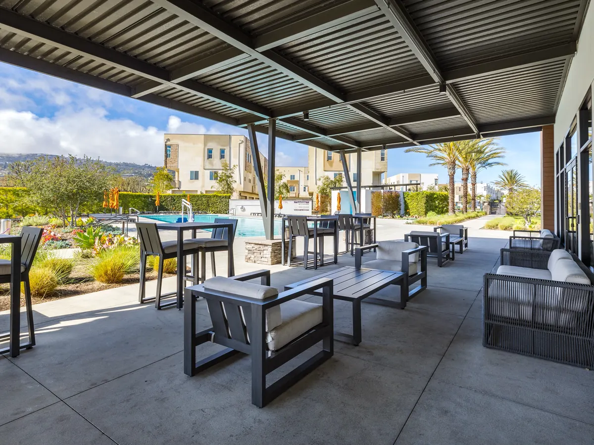 A shaded pavilion with game tables and lounge seating at Ponte Vista in San Pedro