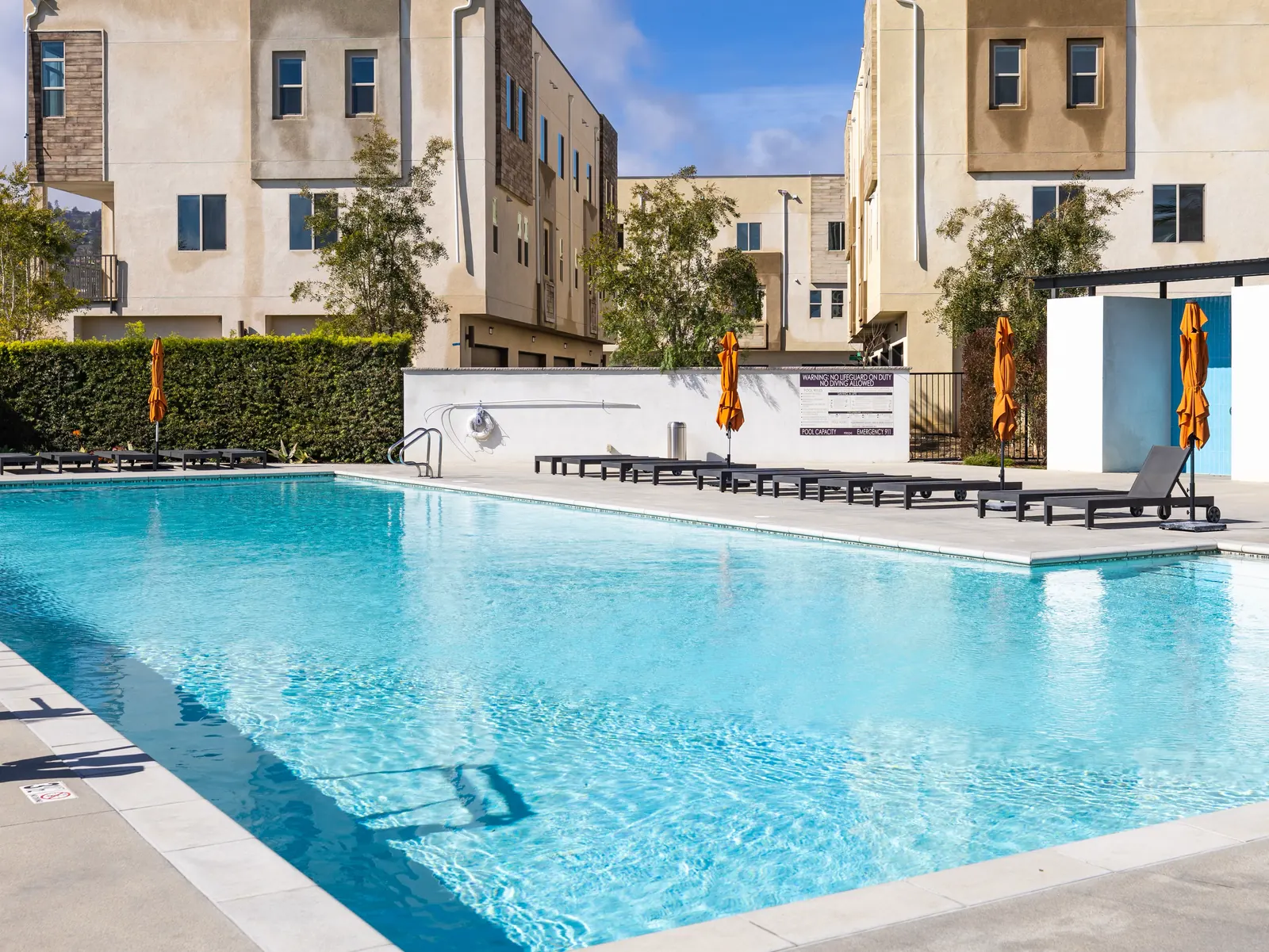 The community swimming pool and sundeck with lounge chairs at Ponte Vista in San Pedro