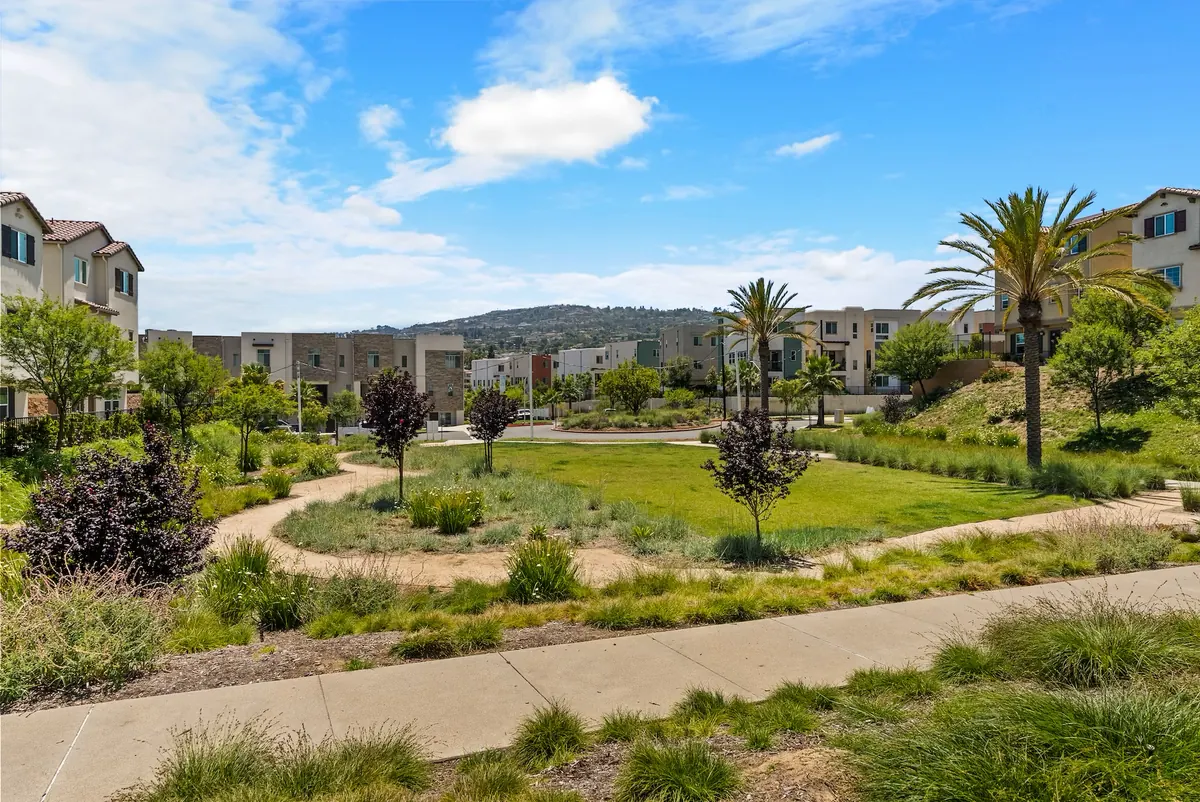Landscaped walking paths winding past the homes toward the hills at Ponte Vista in San Pedro