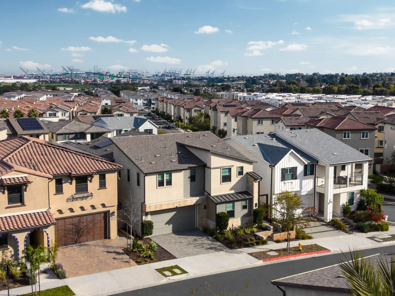 Aerial view of Ponte Vista homes with rooftop solar panels, looking toward the Port of Los Angeles