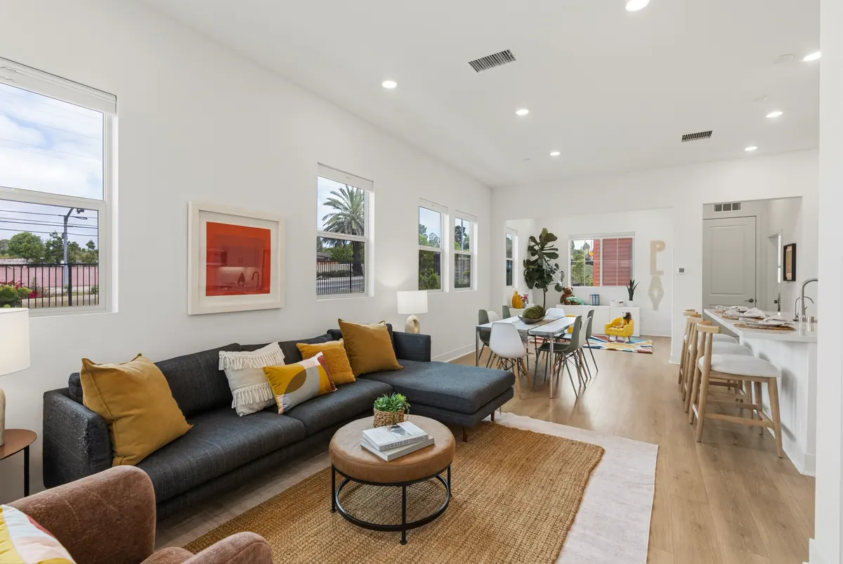 Open living level of a three-story Harbor Pointe home at Ponte Vista with the living area, dining table and kitchen in one connected space