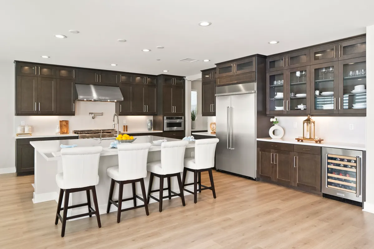 Upgraded kitchen with dark cabinetry in an Estates home at Ponte Vista