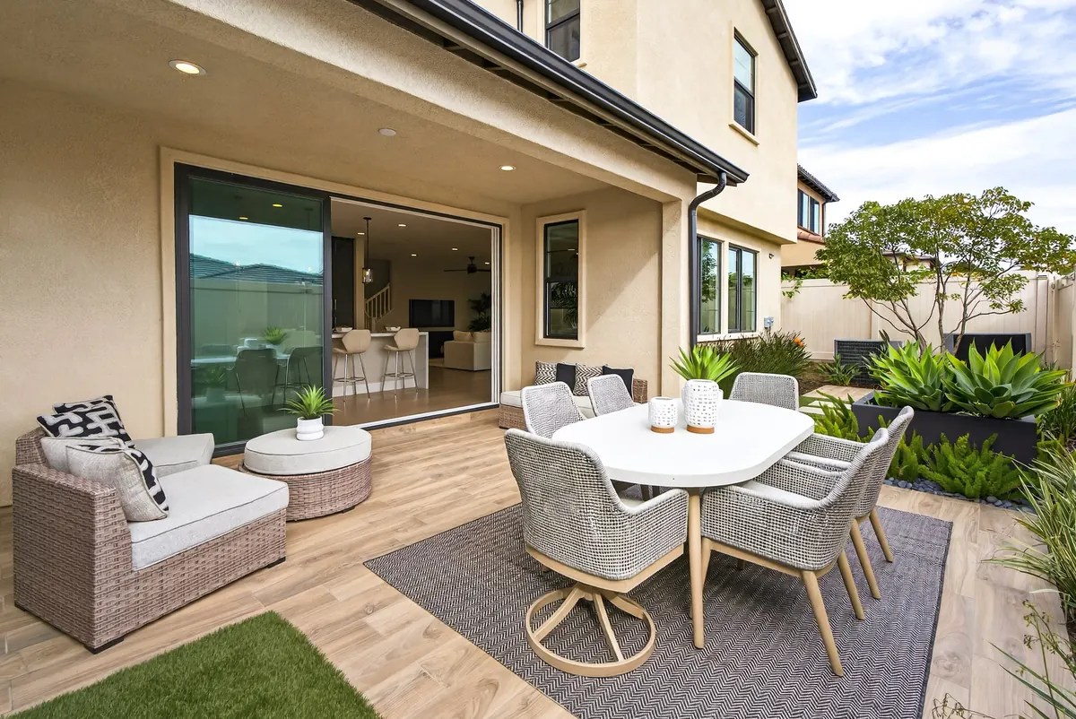 Covered patio and landscaped yard of an Estates home at Ponte Vista