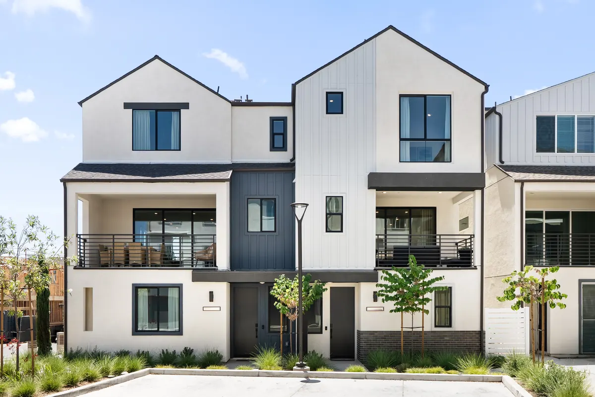 Modern attached homes with white and charcoal facades at The Heights in Ponte Vista